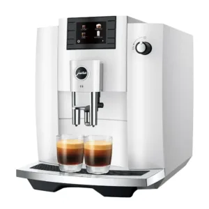 Jura E6 review showing dual coffee spouts brewing two espressos