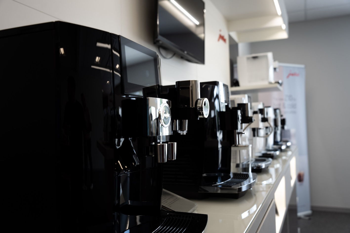 Row of Jura commercial espresso machines on display