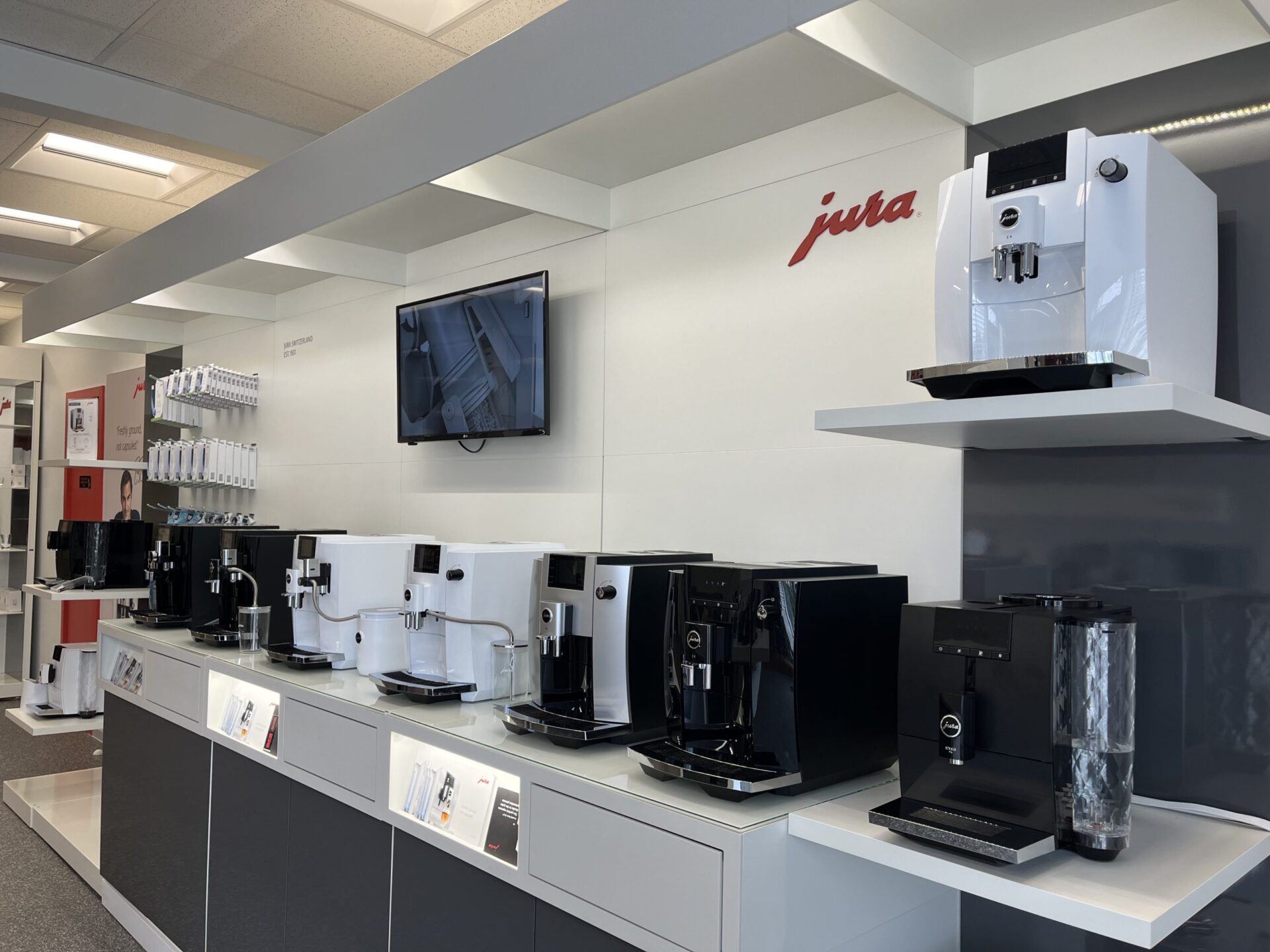 Row of Jura commercial espresso machines in showroom display