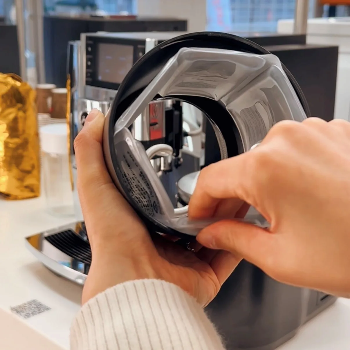 JURA Glacette cooler sleeve being placed inside