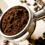 Coffee and Sustainability: a picture of a portafilter with ground coffee inside