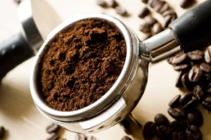 Coffee and Sustainability: a picture of a portafilter with ground coffee inside